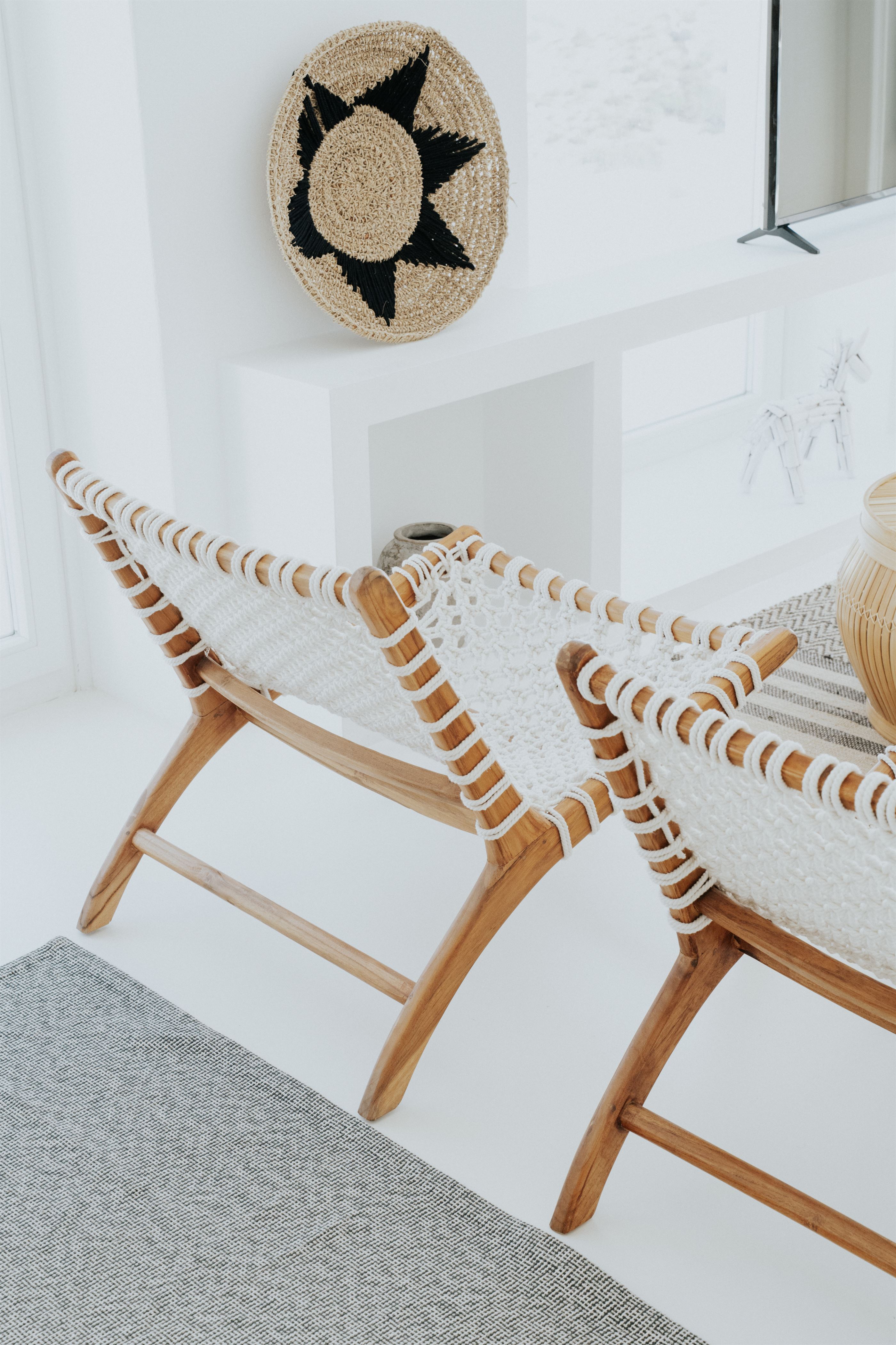 Woven lounge chairs in the bright, minimal living area